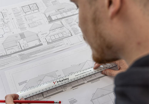 Marley technical team looking at a house drawing